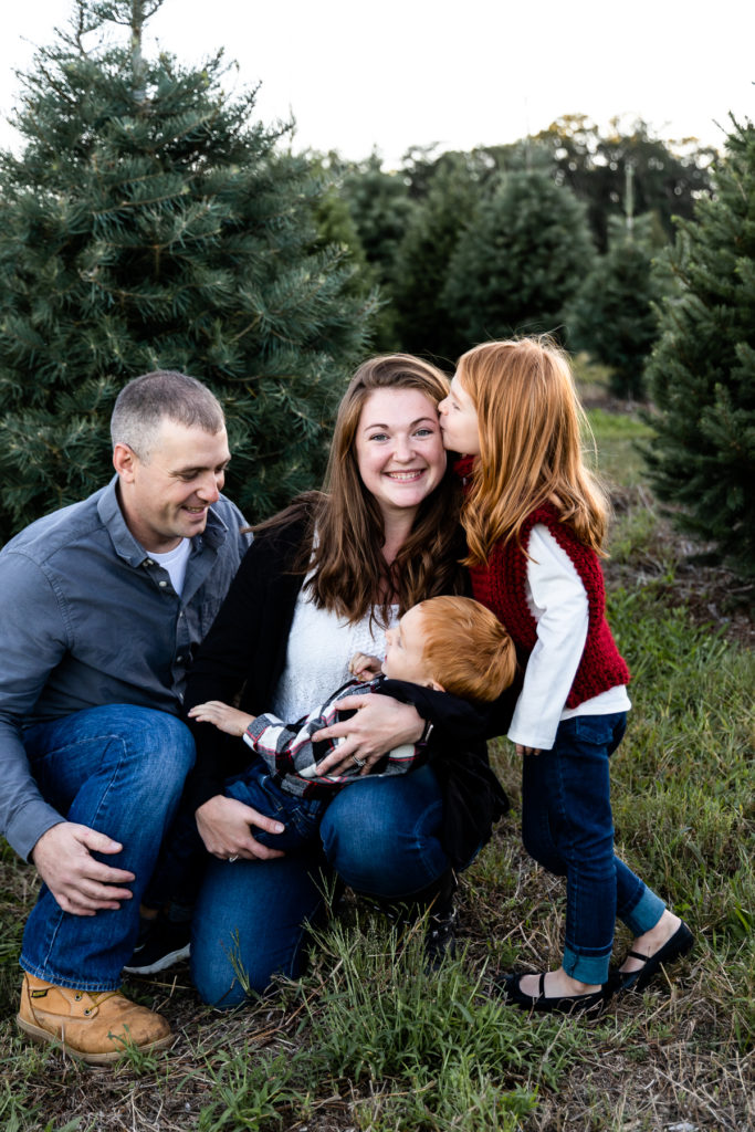 Family snuggling together at Christmas Tree Farm - Connecticut Family Photographer
