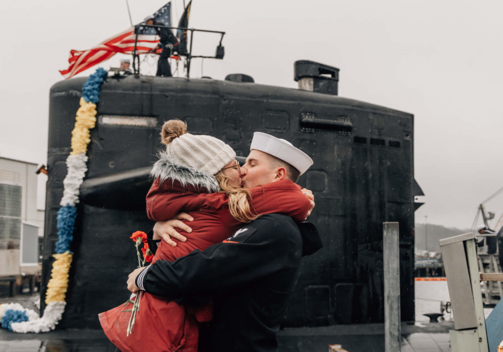 Sailor kisses significant other at USS Newport News military homecoming in Groton, CT on January 3, 2023.