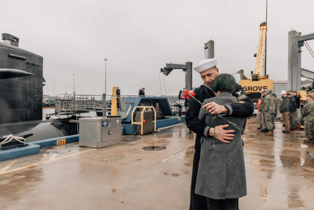 Sailor hugs his daughter at USS Newport News military homecoming in Groton, CT on January 3, 2023.