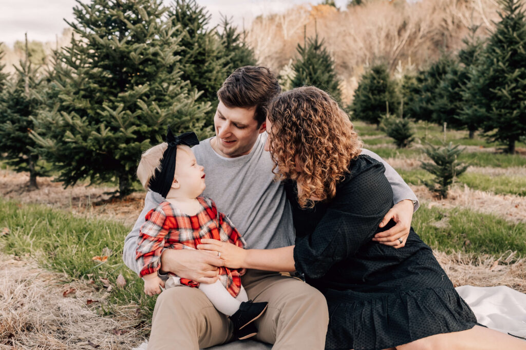 Mother, father, and baby snuggled together at Geer Tree Farm in Preston CT