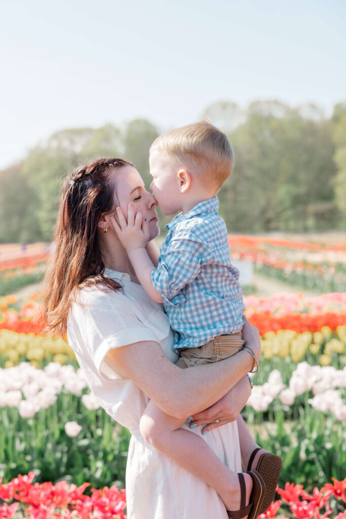 A boy kisses his mother's nose at Wicked Tulips Flower Farm in Preston, CT