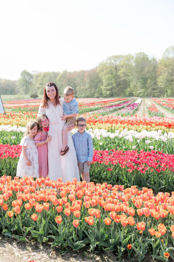 Mom with four children posing for a photo at Wicked Tulips Flower Farm in Preston, CT